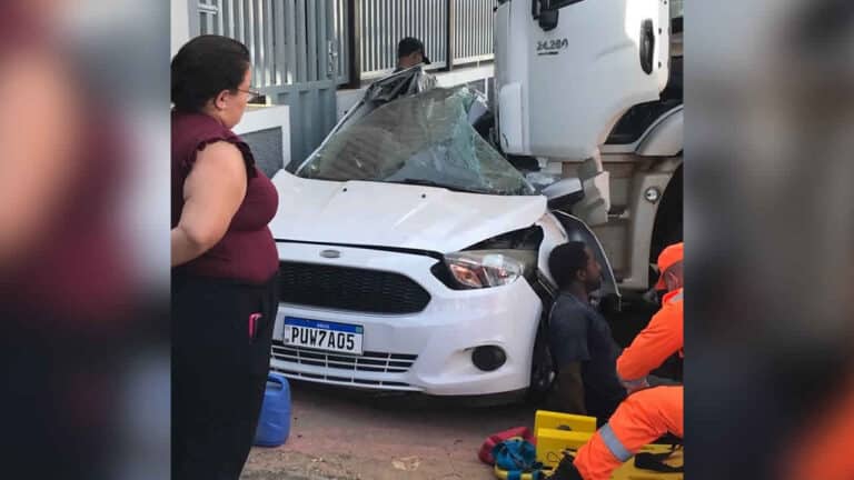 Veículo fica completamente destruído após ser prensado contra parede por caminhão no Centro de João Pinheiro