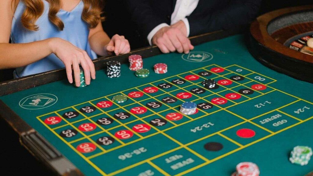 elderly couple gambling on slot machine in casino